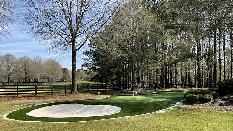Southern Greens in Huntsville providing weather-resistant synthetic turf for residential putting greens, ensuring year-round playability.