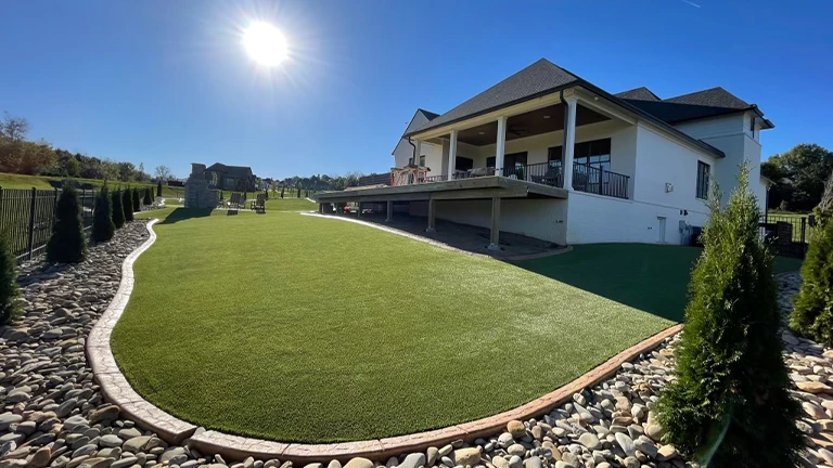 Eco-friendly synthetic turf in a Huntsville home backyard, offering a low maintenance and pet-friendly artificial lawn solution.