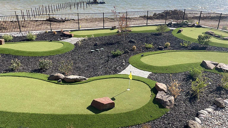Advanced artificial turf technology in Huntsville putting greens by Southern Greens, offering a realistic golfing experience.